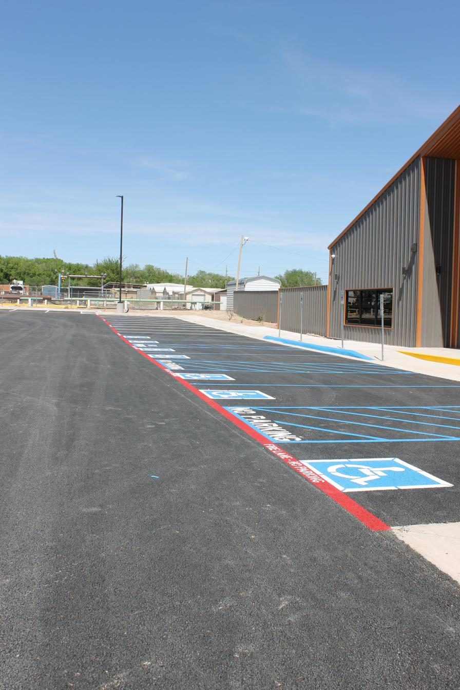 Finished commercial parking lot with new white striping and red fire lane
