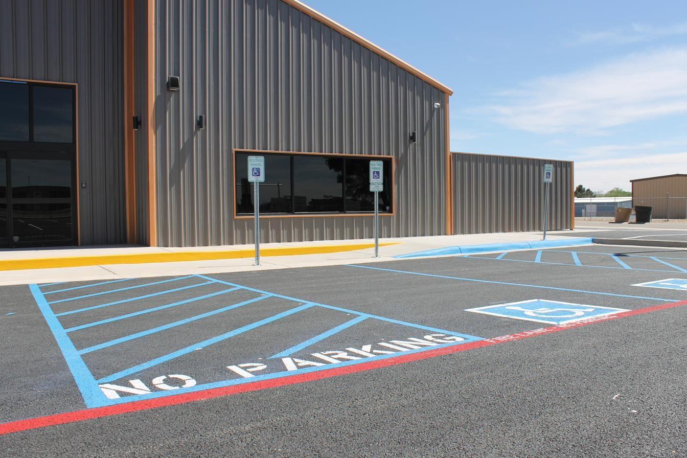 ADA-compliant handicap parking with blue stenciling and signage