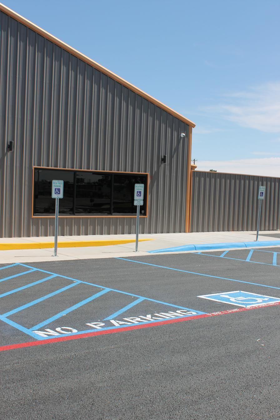 ADA handicap parking stencil with blue striping and access aisle