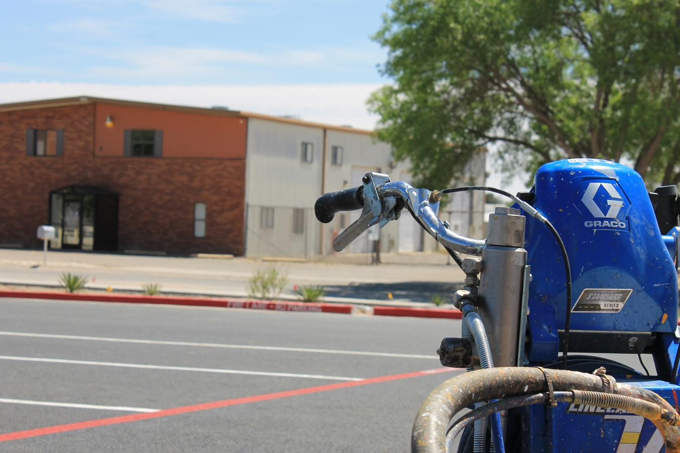 Graco striping machine in a parking lot ready to lay paint